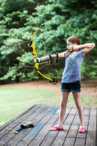 a young girl practicing archery