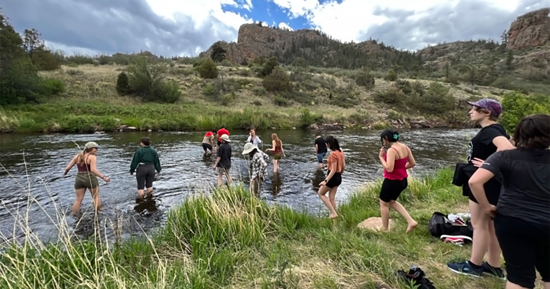 A group of students on the banks of the rive that runs through Phantom Canyon