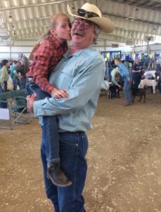 CJ Mucklow with a young girl at a county fair