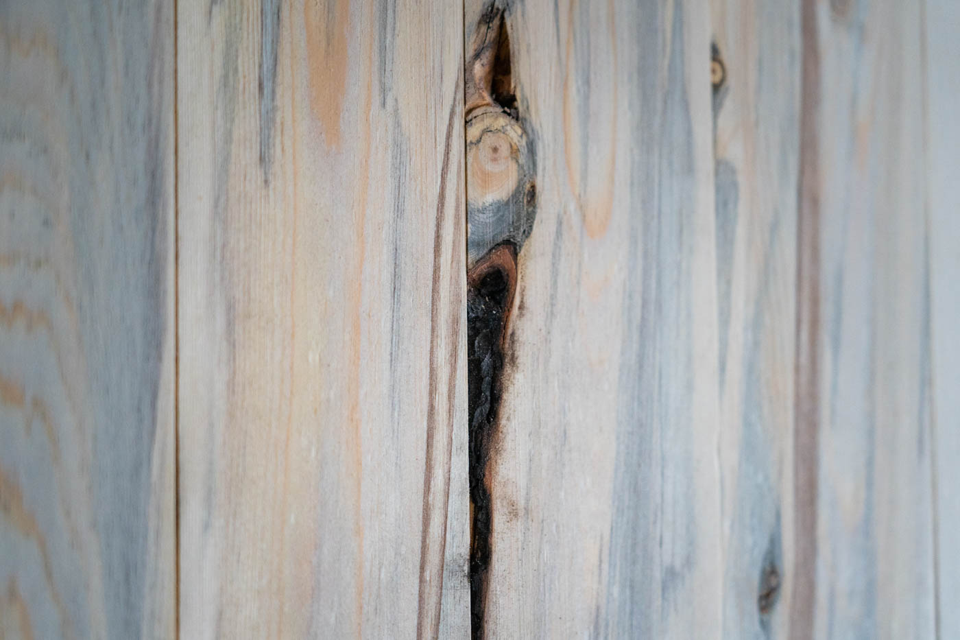 A charred section of wood is visible in a cabinet face.