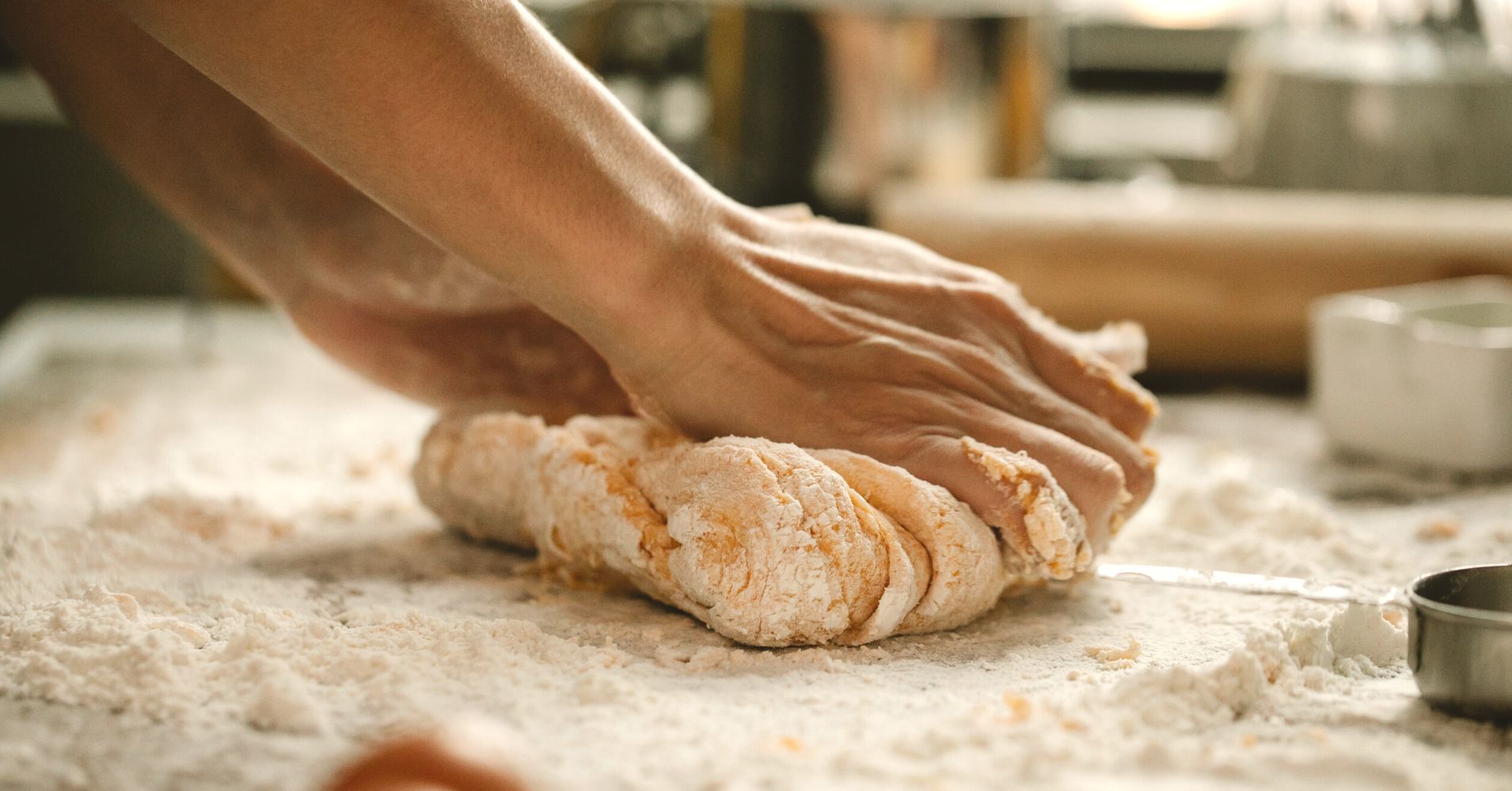 A baker kneads dough