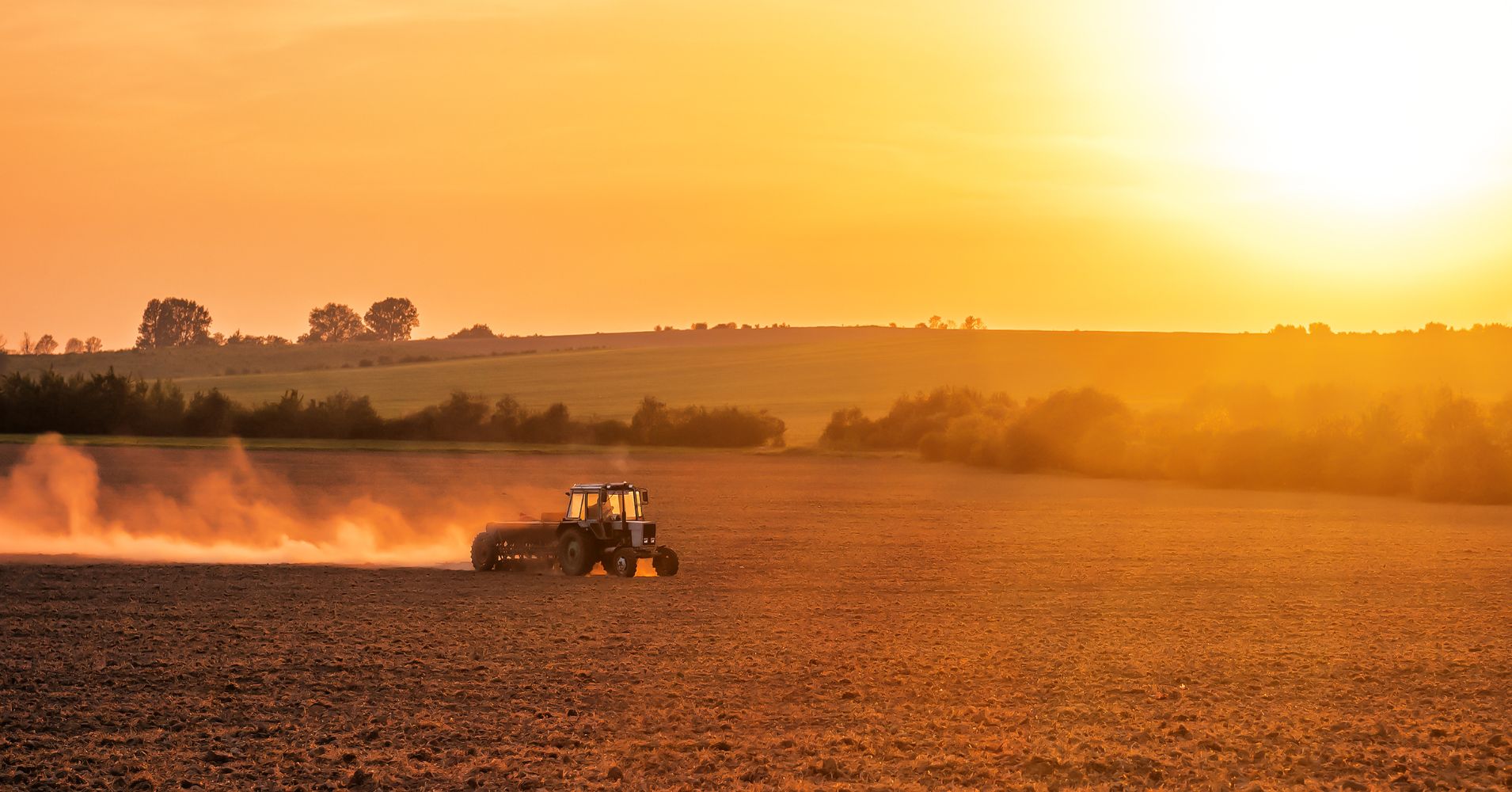 a tractor at sunset