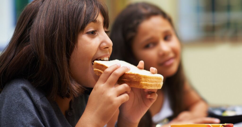 a kid eating a sandwich